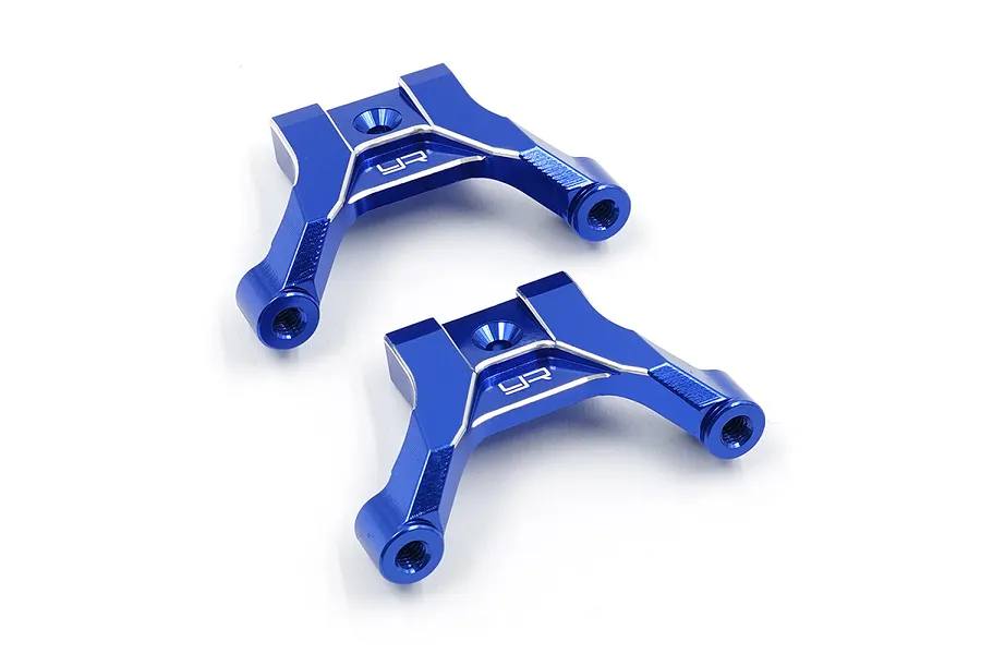 Two deep blue anodized aluminium upper arm mounts for RC cars, featuring the Yeah Racing logo engraved on the top surface.
