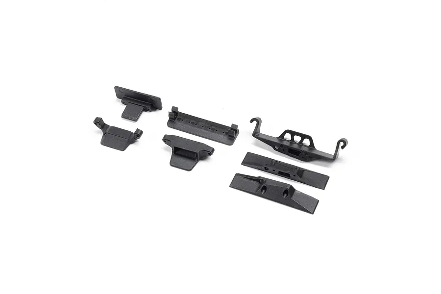 A set of black plastic RC battery tray components and chassis mounts from Axial, arranged on a white background.