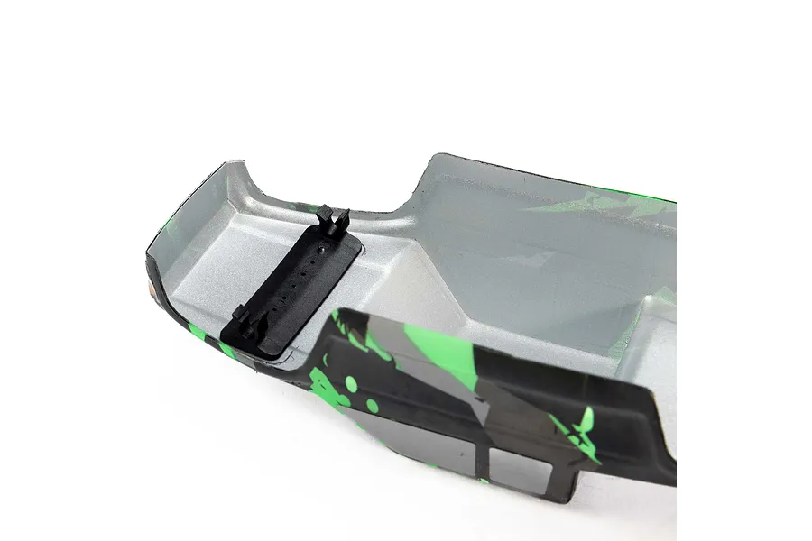 Interior view of a Pro-Line Coyote RC body shell featuring a green and black tear pattern with a black plastic mounting bracket attached.