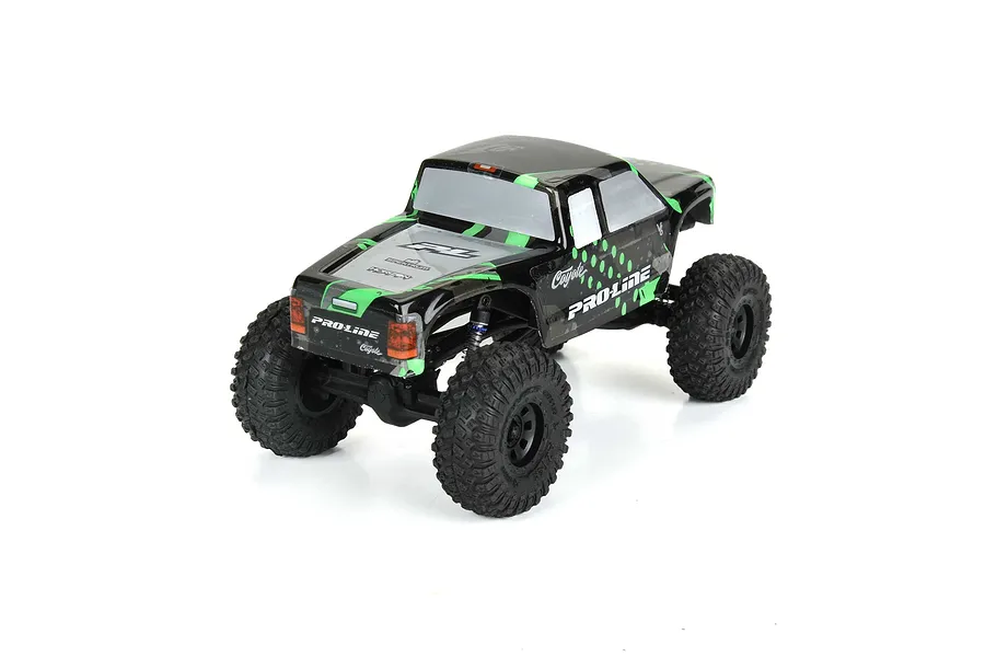 A Pro-Line Coyote RC crawler body shell in green and black, mounted on a small RC chassis with black off-road tires.