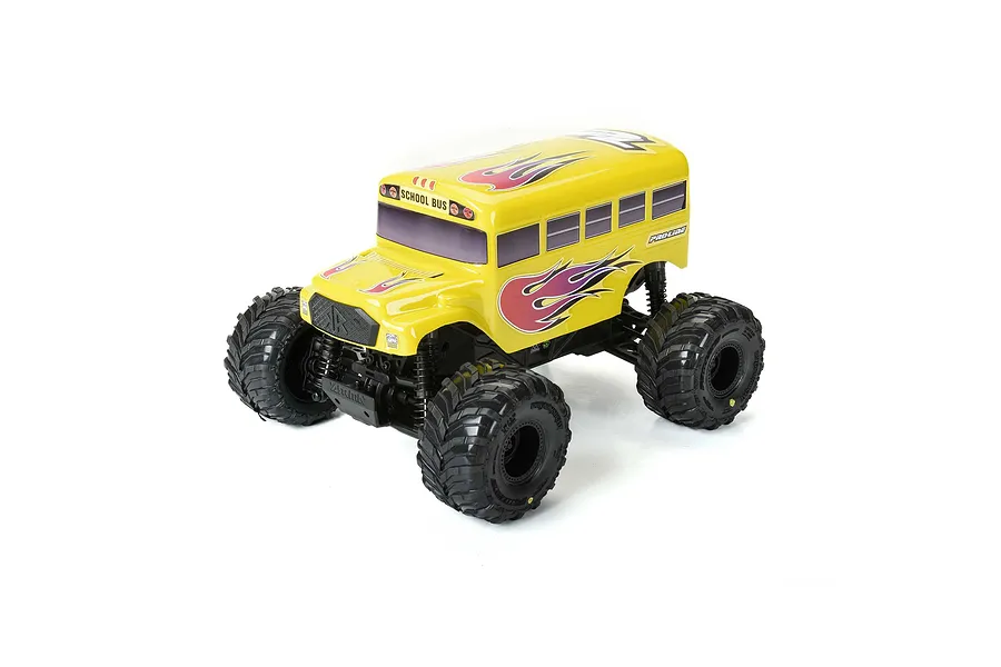 A yellow Pro-Line RC school bus body shell mounted on a 1/16 scale monster truck chassis with black off-road tires.