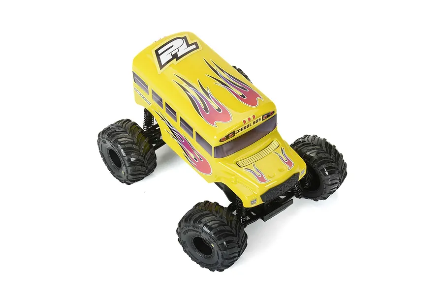 A yellow Pro-Line school bus RC body shell mounted on a monster truck chassis, featuring flame decals and black windows.
