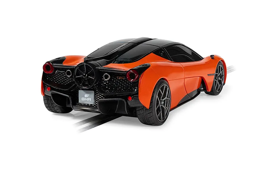 Rear three-quarter view of a 1/32 scale orange and black Scalextric GMA T.50 slot car on a track.