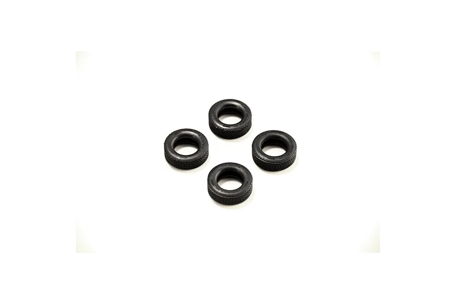 Four small black rubber model car tires arranged in a diamond pattern on a white background.