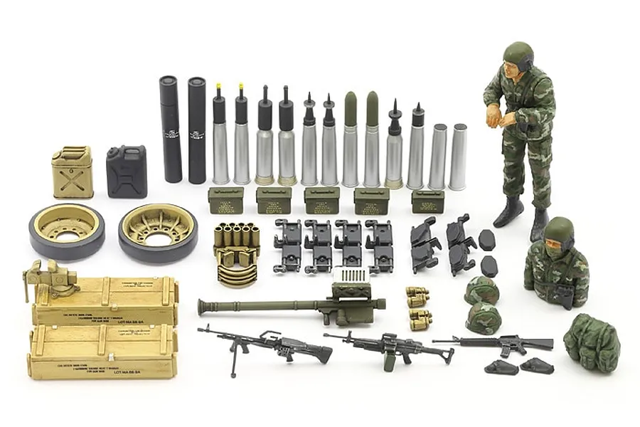 A collection of assembled and painted plastic model accessories for a 1/35 scale tank kit, including ammunition, crew figures, weapons, and storage crates.