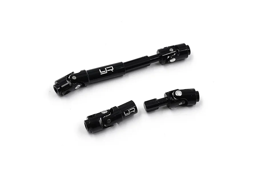 Three black aluminium RC centre driveshafts with universal joints, featuring the Yeah Racing logo, isolated on a white background.