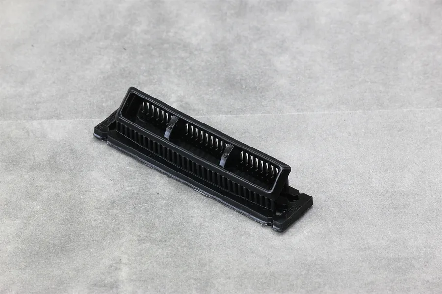 A black plastic Pandora RC A-Type turbo duct accessory for 1/10 scale RC car bodies, shown from an elevated angle on a grey surface.