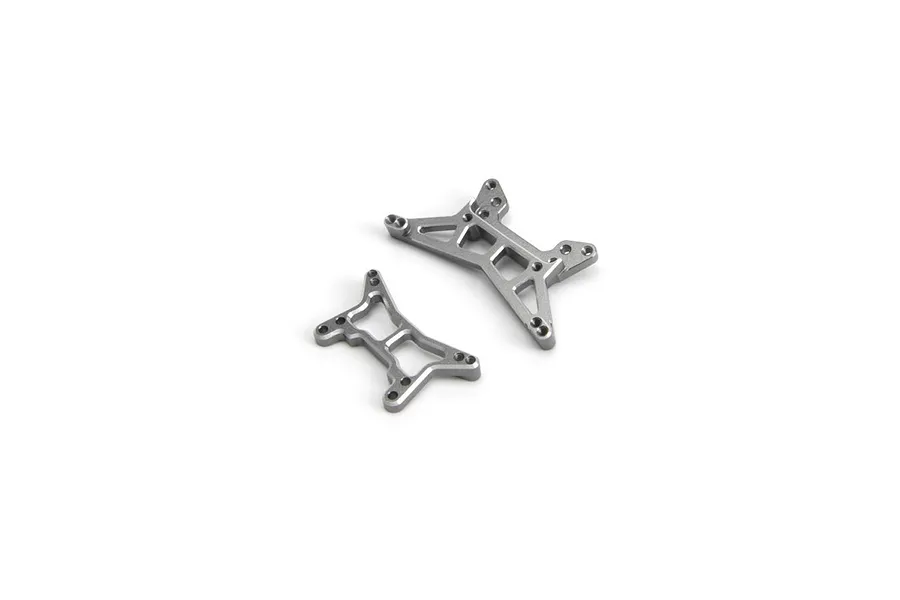Two grey aluminium RC shock towers for Maverick models, shown from a top-down perspective on a white background.