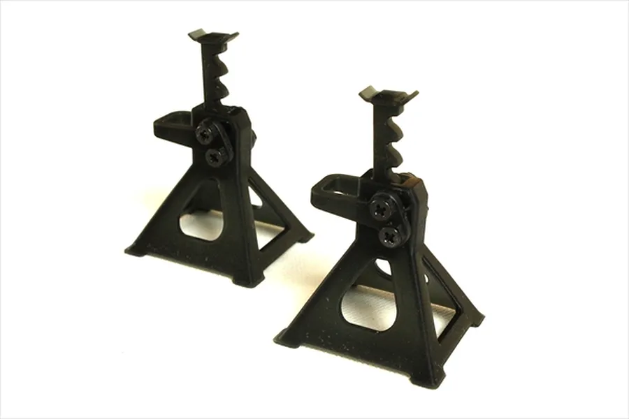 Two black 1/10 scale RC jack stands standing on a white background.