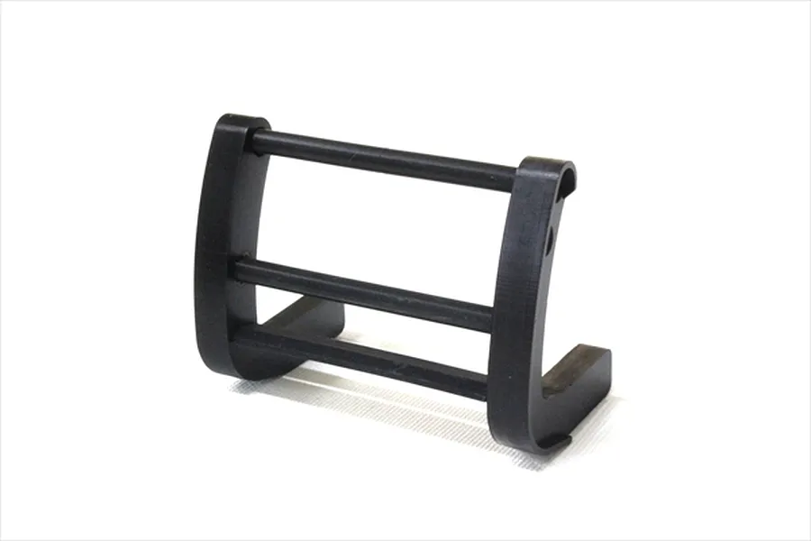 A black plastic RC grill guard accessory for 1/10 scale model cars, shown against a white background.