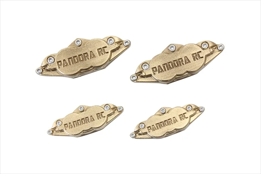 Four gold-coloured Pandora RC brake caliper accessories for 1/10 scale RC cars arranged on a white background.