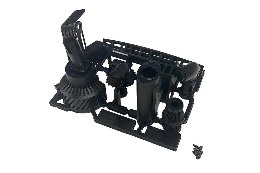 Black plastic RC car muffler and engine accessory parts on a sprue frame with three small screws.