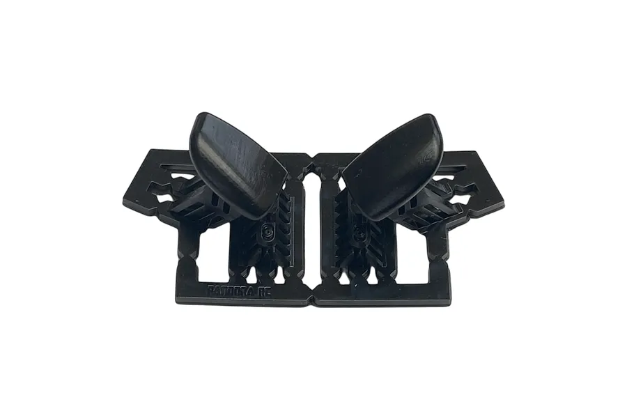 A pair of black plastic RC car door mirrors still attached to their original injection molding sprue frame.