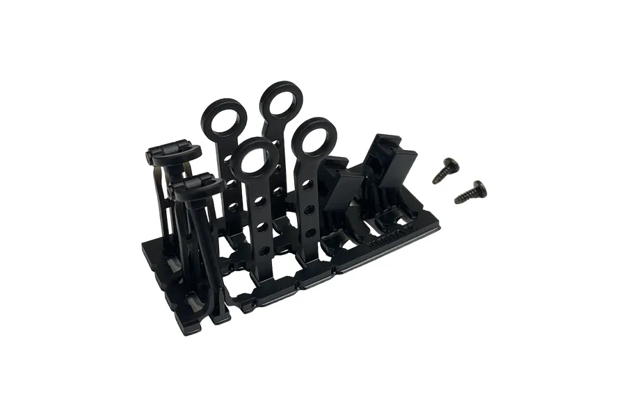 A set of black plastic RC tow hooks and accessories on a parts tree with two small screws on a white background.