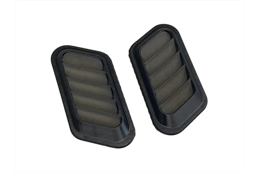 Two black plastic bonnet duct vents for 1/10 scale RC car bodies.