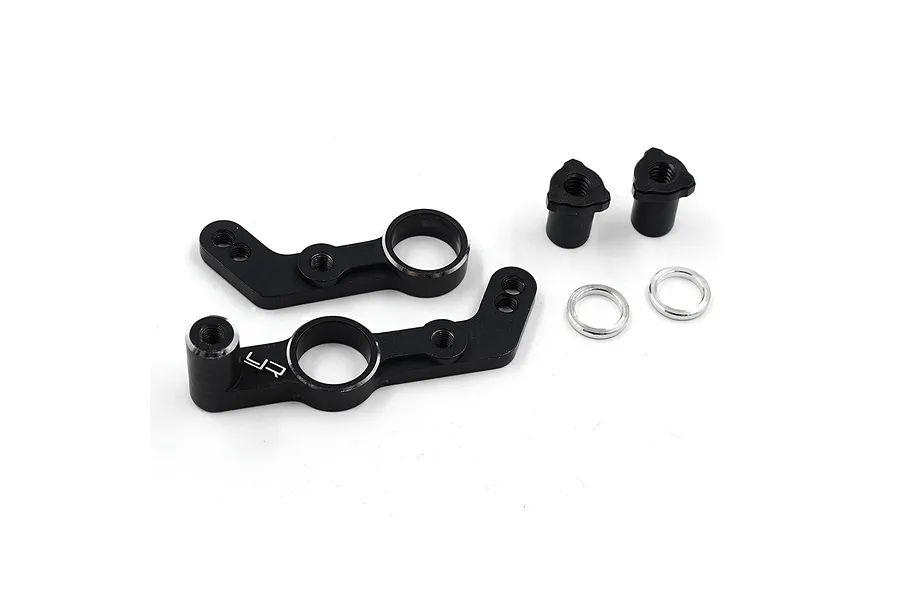 A set of black anodized aluminium steering assembly parts for an RC car, including two steering arms, two threaded posts, and two silver washers.