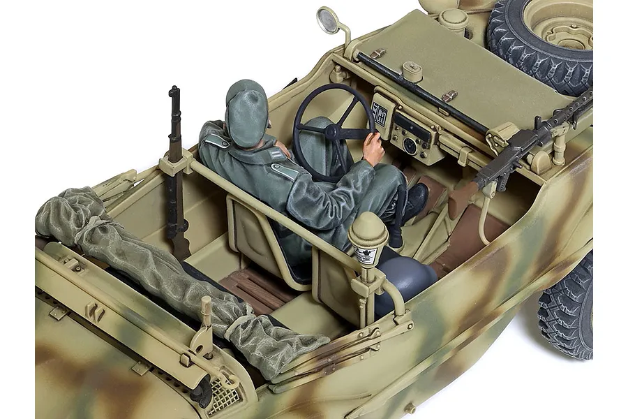 High-angle view of a 1/35 scale Tamiya German Schwimmwagen T166 model kit, showing the detailed interior, driver figure, and camouflage paint scheme.