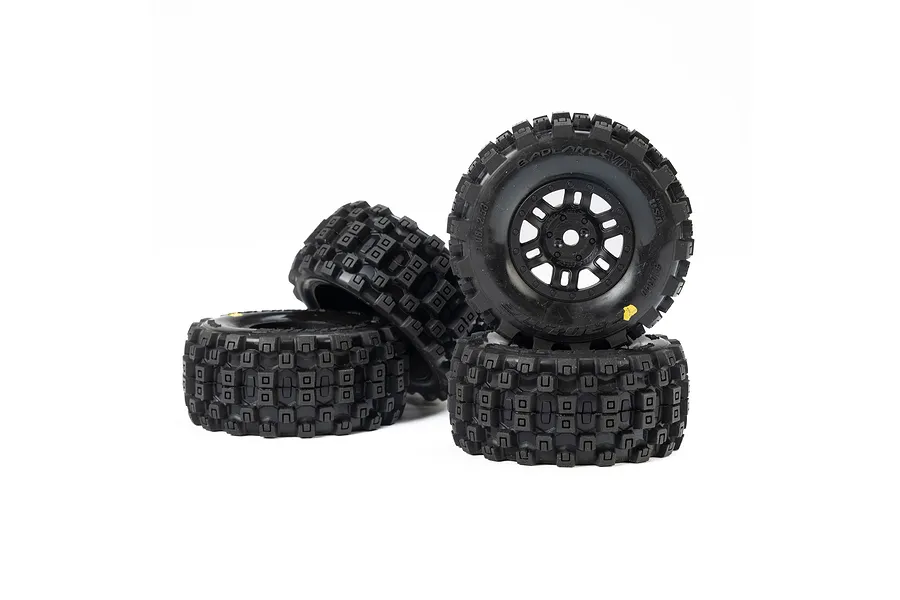 A set of four Pro-Line 1/16 Badlands MX RC tyres pre-mounted on black Split Six rims, shown stacked against a white background.