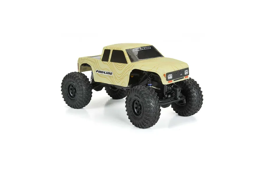 A Pro-Line Coyote RC crawler body shell in tan topographical pattern mounted on a small scale RC chassis against a white background.