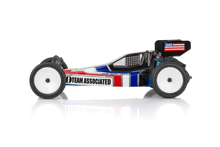Side profile of a Team Associated RB10 1/10 scale RC buggy with a red, white, and blue retro livery on a white background.