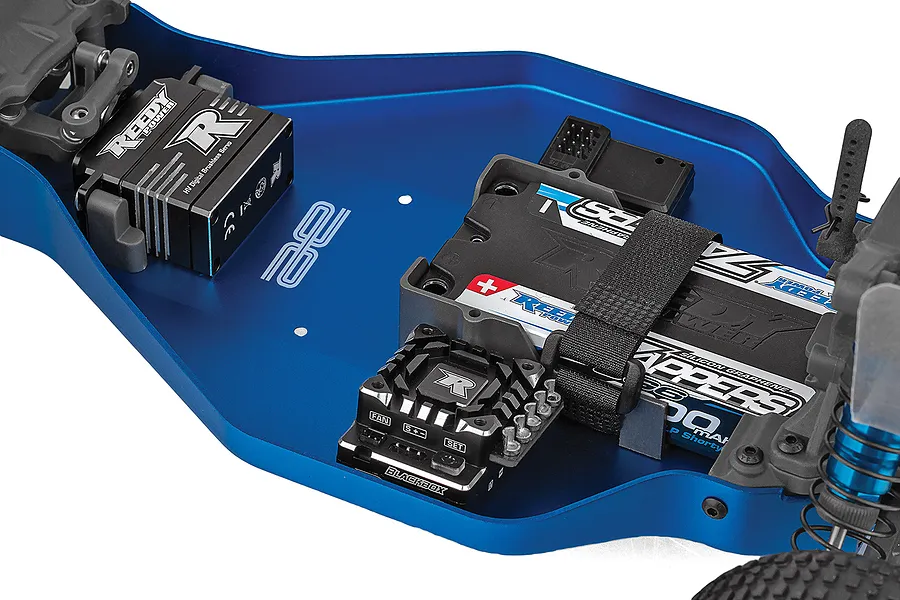 Top-down view of a blue anodized aluminum RC buggy chassis showing a Reedy servo, Blackbox ESC, and a Reedy battery pack installed.