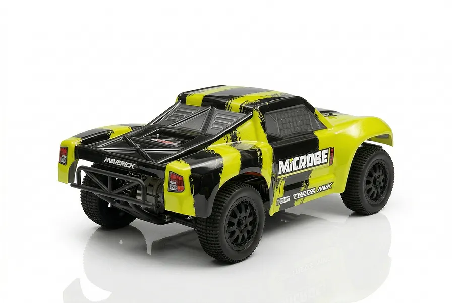 A rear three-quarter view of the Maverick MiCROBE SC Flux RC short course truck in yellow and black, featuring a roll cage and off-road tires.