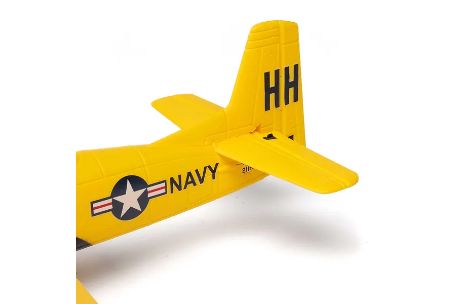 Close-up of the yellow tail section of a HobbyZone T-28 Trojan RC plane, showing the vertical stabilizer with HH markings and a US Navy insignia.
