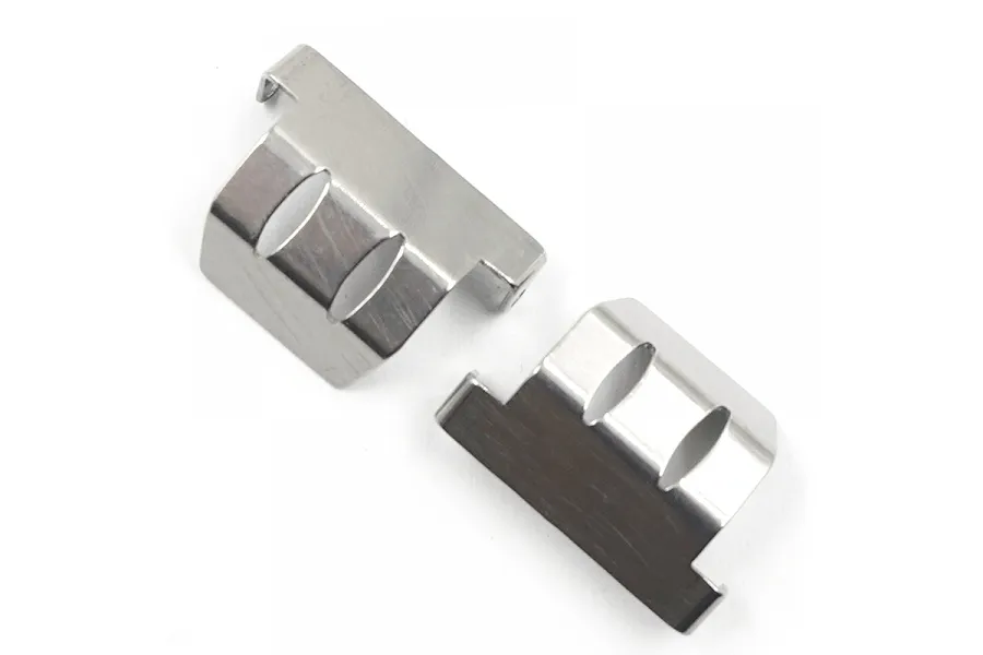 Two silver-coloured stainless steel skid plates for an RC car chassis, shown from an overhead angle against a white background.