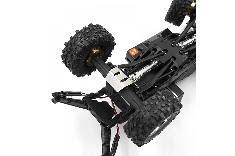 A stainless steel skid plate installed on the underside of an RC crawler chassis, showing the axle and drivetrain components.