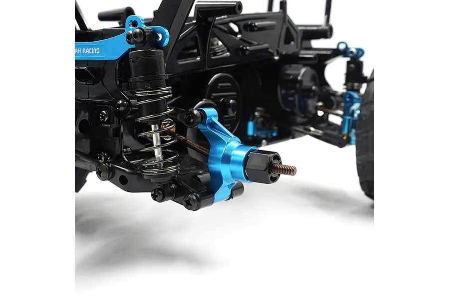 Close-up of a blue aluminium rear hub installed on an RC car chassis with black suspension components.