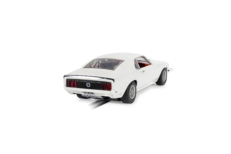 Rear three-quarter view of a white Scalextric 1/32 scale Ford Mustang slot car on a track.