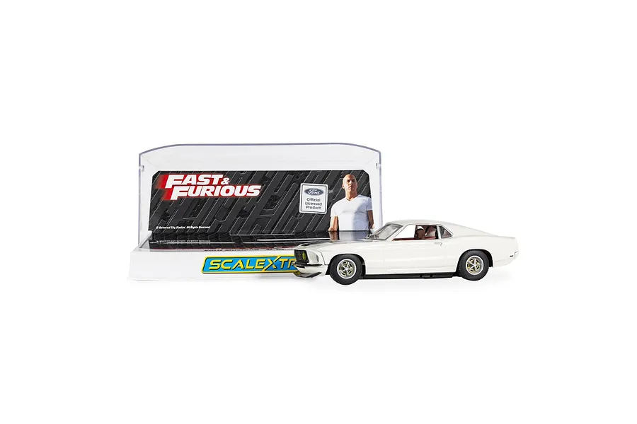 A 1/32 scale white Ford Mustang slot car from the Fast and Furious series, displayed in front of its branded plastic display case.
