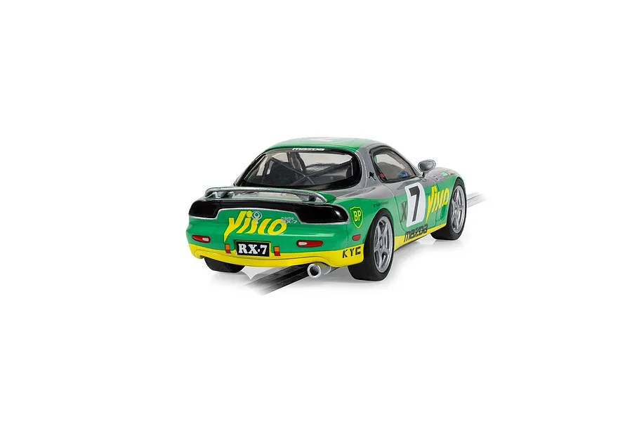 A 1/32 scale Scalextric Mazda RX-7 FD slot car in green, silver, and yellow racing livery with number 7, viewed from the rear three-quarter angle.