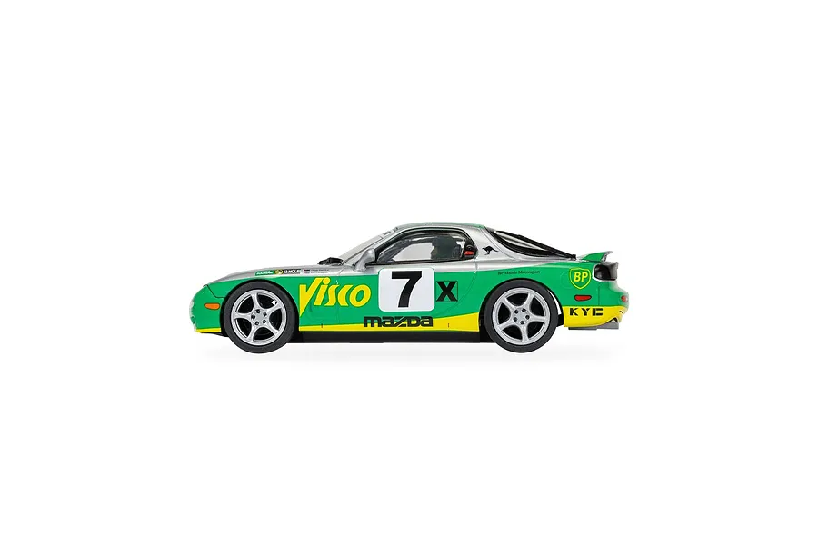 Side profile of a Scalextric 1/32 scale Mazda RX-7 FD slot car in green, silver, and yellow racing livery with number 7.