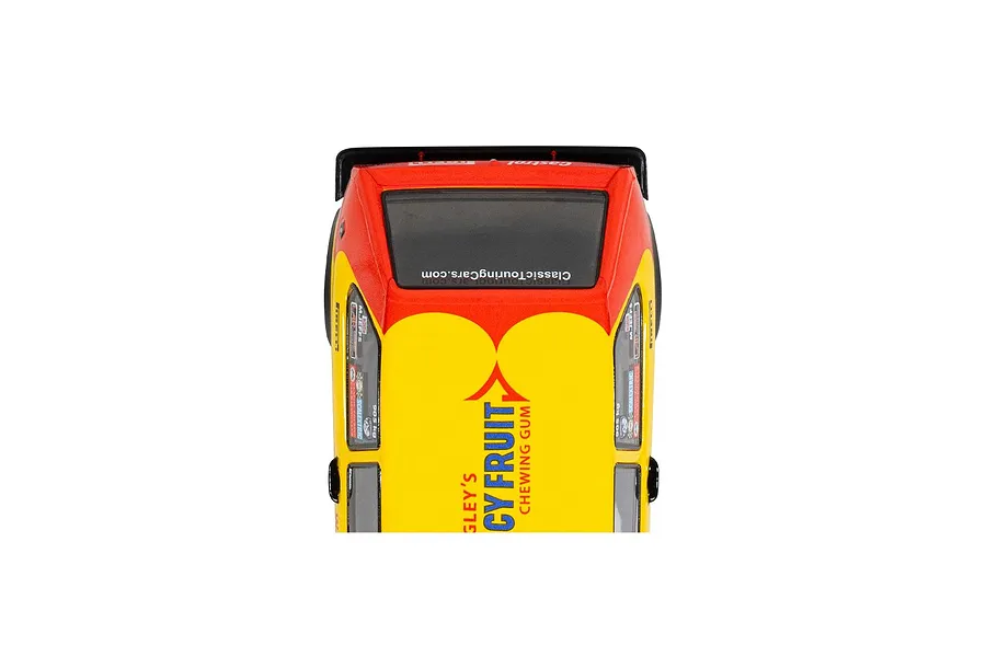 Top-down view of a Scalextric 1/32 scale Volkswagen Golf MK 1 slot car featuring a yellow and red livery with Juicy Fruit branding.