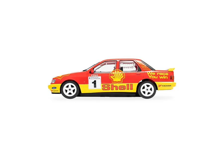 Side profile of a 1/32 scale Scalextric Ford Sapphire RS500 slot car in red and yellow Shell livery with number 1.