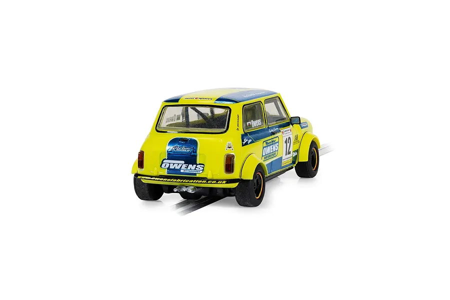 A rear three-quarter view of a yellow and blue Scalextric 1/32 scale Mini Miglia slot car, number 12, driven by Endaf Owens.