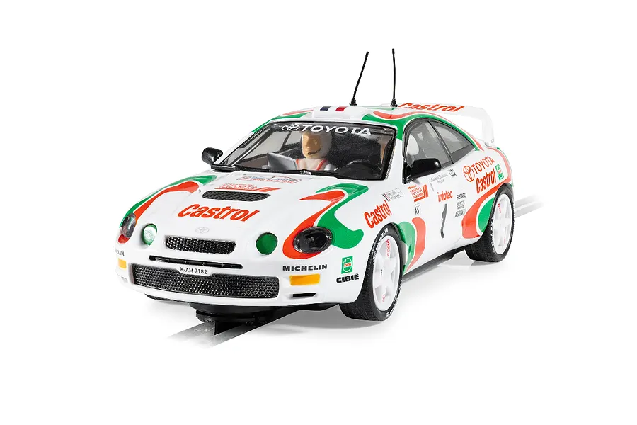 Scalextric 1/32 scale Toyota Celica GT-Four rally slot car in white, green, and red Castrol livery on a track.