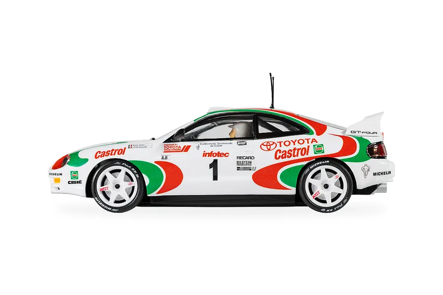 Side view of a 1/32 scale Scalextric Toyota Celica GT-Four rally slot car in white, red, and green Castrol livery with number 1 on the door.