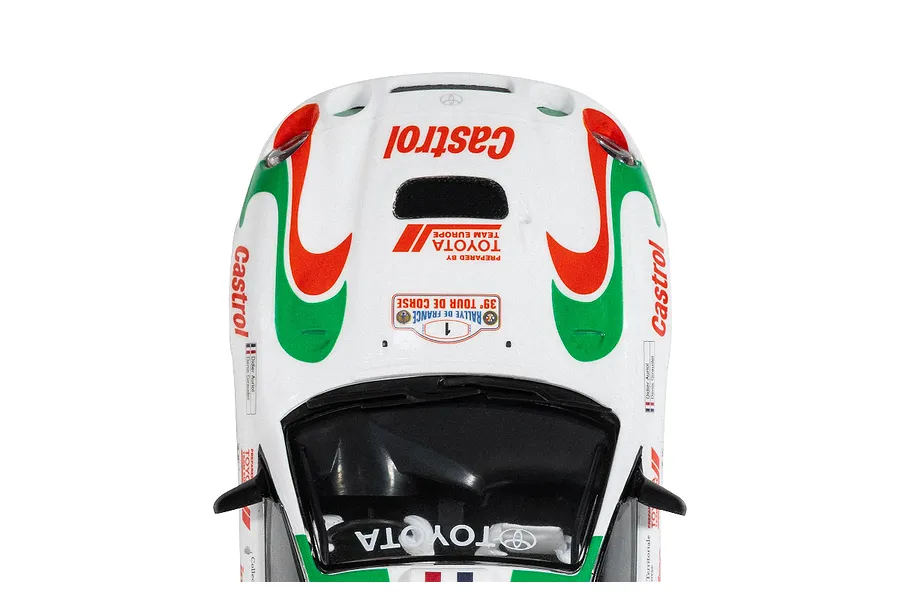 Top-down view of a 1/32 scale Scalextric Toyota Celica GT-Four slot car featuring the iconic white, red, and green Castrol rally livery.