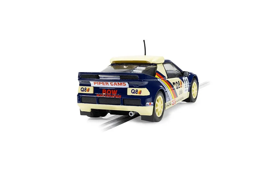 Rear three-quarter view of a Scalextric 1/32 scale Ford RS200 slot car in blue and cream livery with Q8 Oils branding on a track.