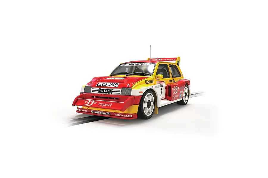 A Scalextric 1/32 scale Austin Metro 6R4 slot car in red, yellow, and white Castrol livery with number 33, shown on a slot car track.
