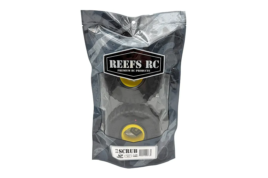 Two Reefs RC 2.2 inch Scrub crawler tyres with yellow foam inserts inside a branded plastic retail bag.