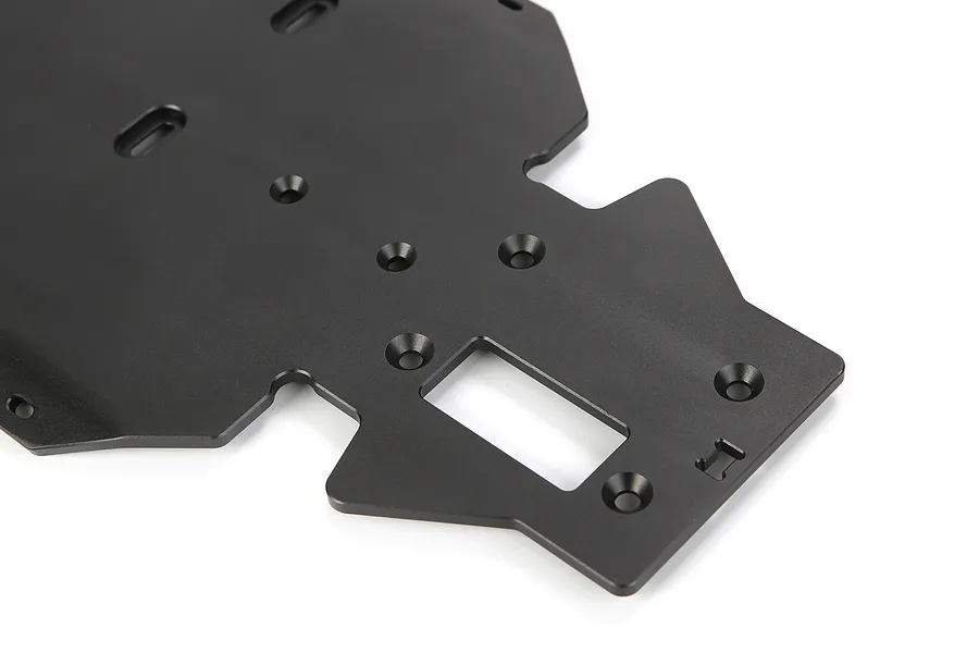 A black anodized aluminium main chassis plate for an RC vehicle, featuring various mounting holes and a rectangular cutout.