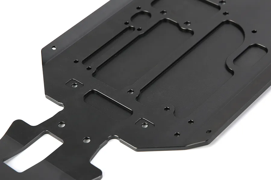 A black anodized aluminium main chassis plate for an RC vehicle, featuring various mounting holes and milled cutouts.