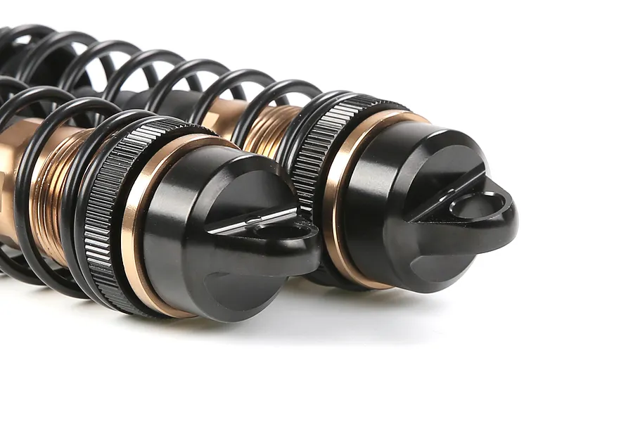 Two Rovan aluminium front adjustable RC shock absorbers in bronze and black finish, shown close-up against a white background.