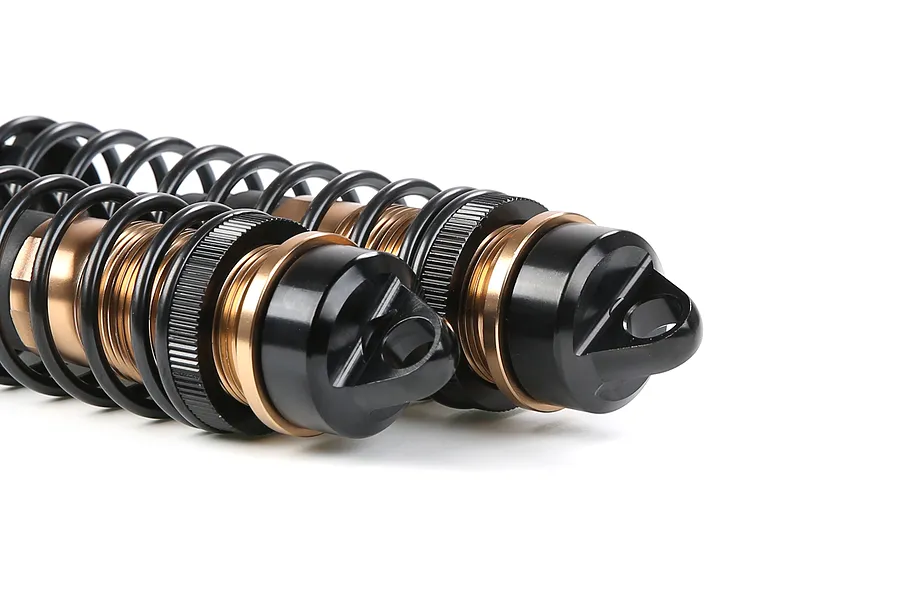 A pair of Rovan aluminium adjustable RC shock absorbers in bronze and black finish, shown against a white background.