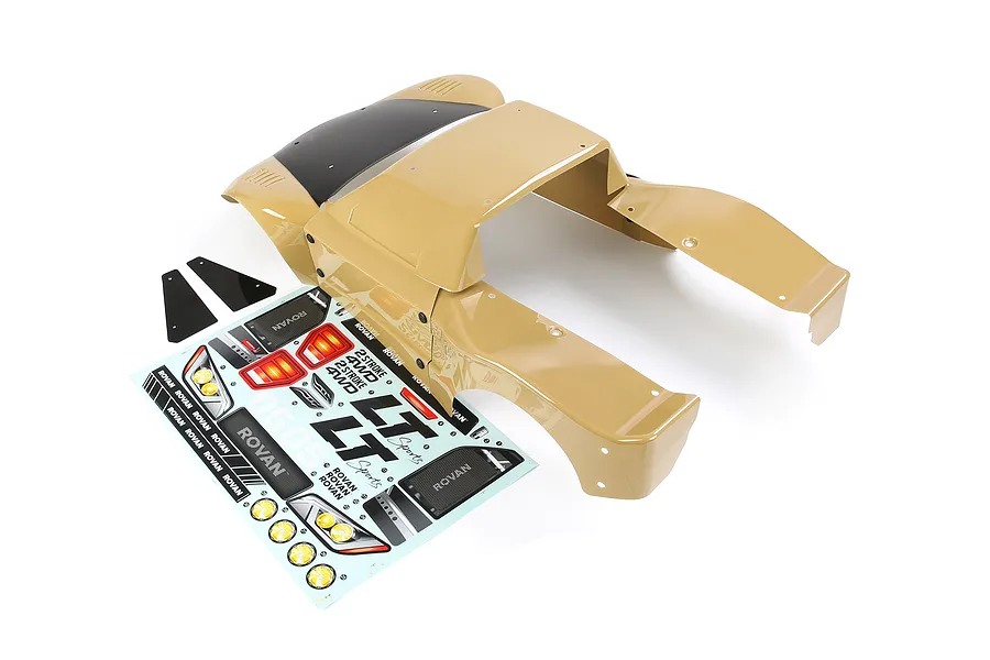 A tan Rovan 1/5 scale RC short course body shell with a black roof section, accompanied by a decal sheet and two black plastic mud flaps.
