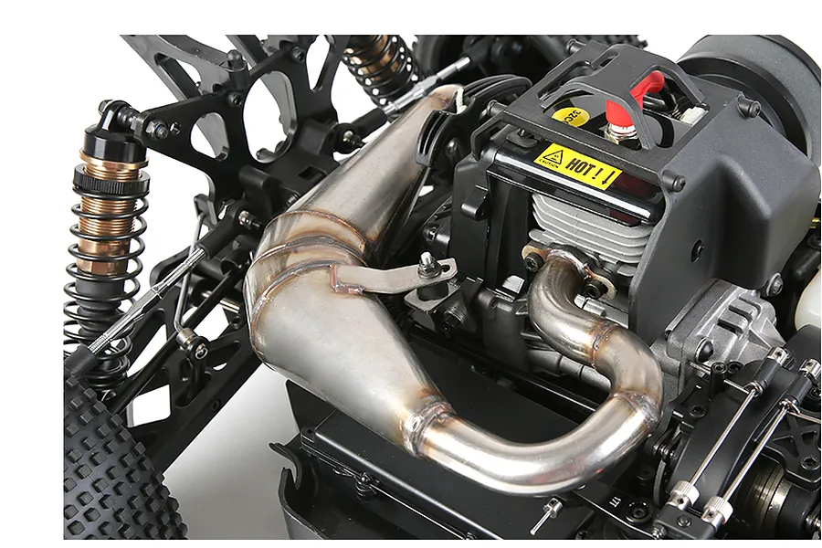 Close-up of a stainless steel tuned exhaust pipe installed on a large-scale RC buggy engine.