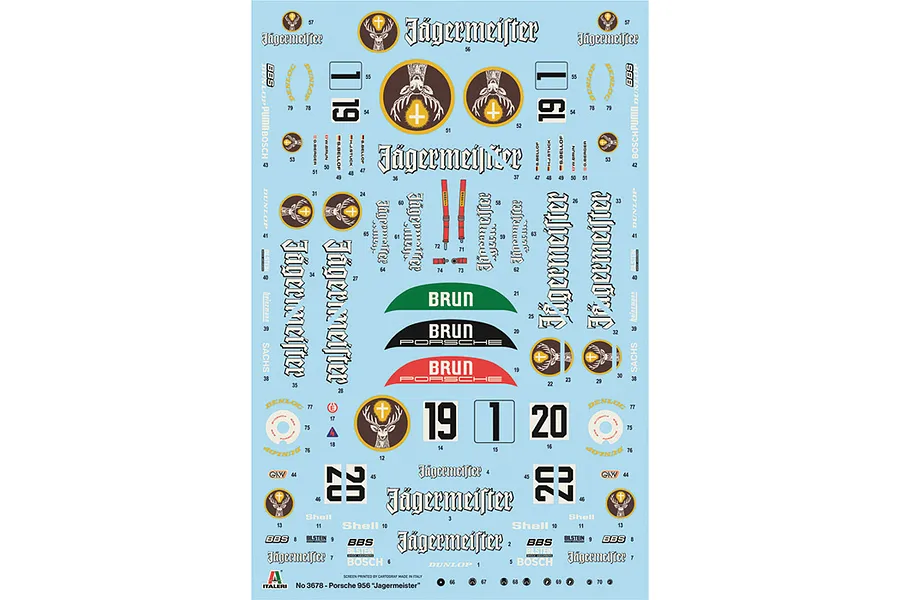 A decal sheet for the Italeri 1/24 Porsche 956 Jägermeister model kit, featuring various logos, racing numbers, and sponsor decals on a light blue backing.